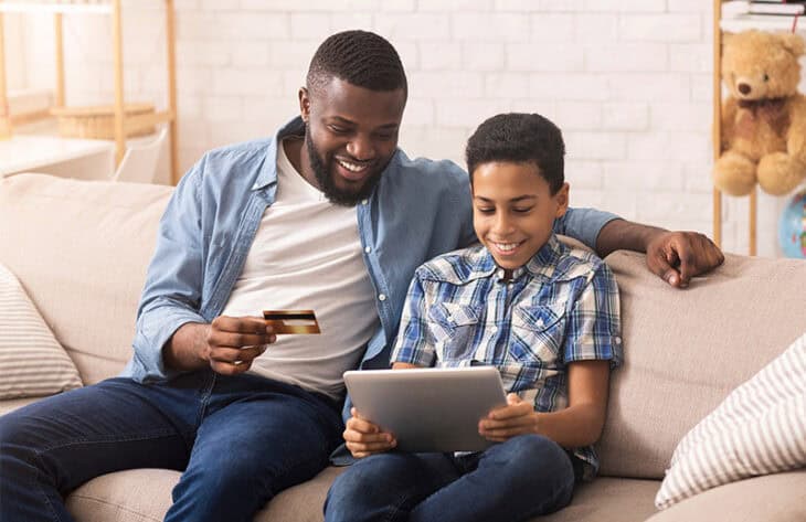 Father teaching son about his new debit card.